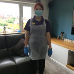 Helen wearing PPE in a home