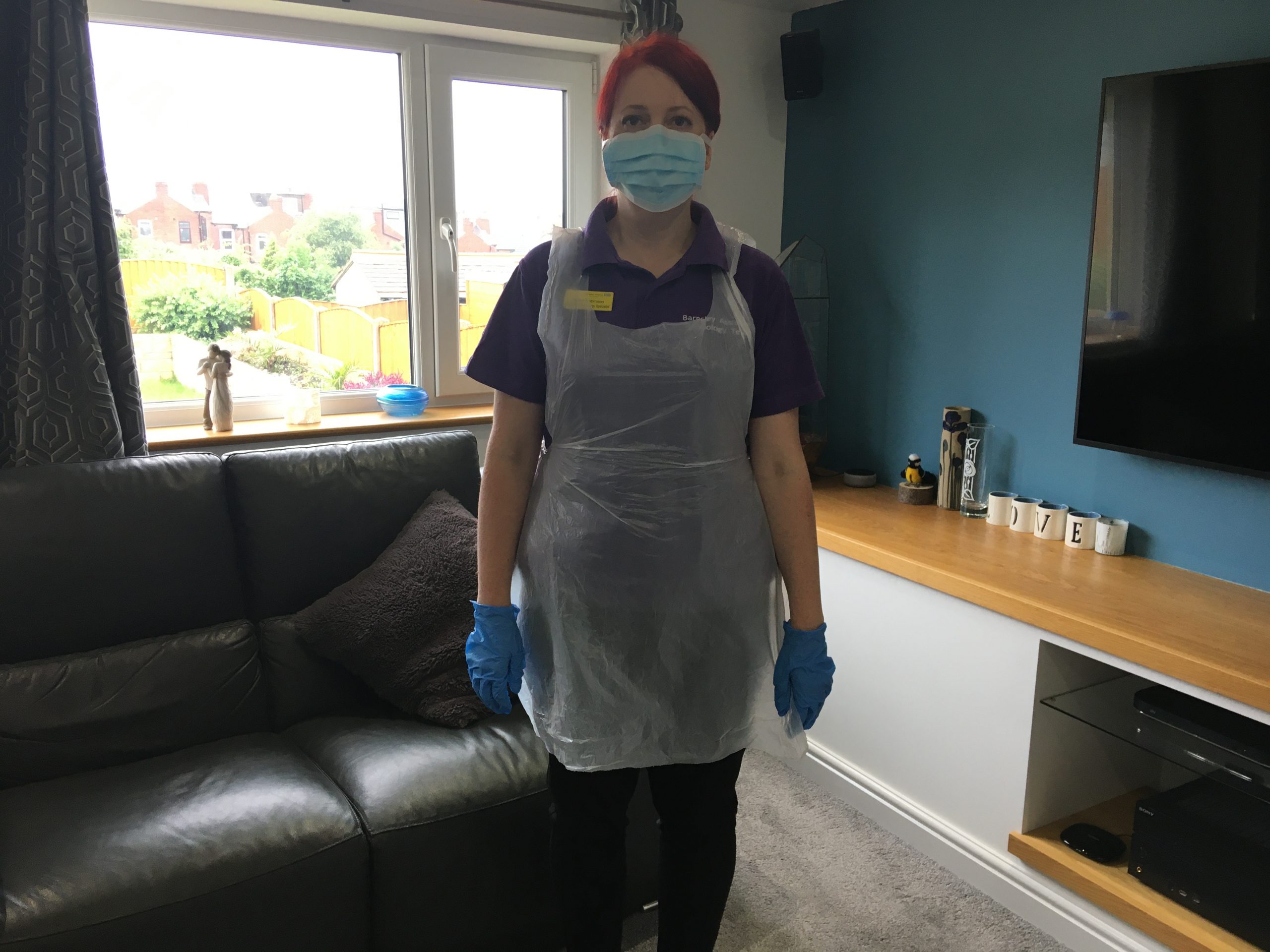 Helen wearing PPE in a home